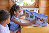 A child joyfully reading the Tooth Fairy Collection Gifts book with friends, illustrating the fun and excitement of waiting for the tooth fairy.